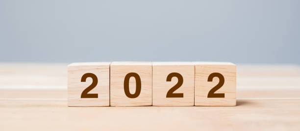 istock 2022 wooden cube blocks on table background. Resolution, plan, review, goal, start and New Year holiday concepts 1323488266