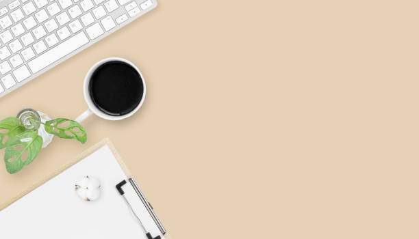 istock Minimal Office desk table top view with office supply and coffee cup on a table with copy space, workplace composition, flat lay 1323492499