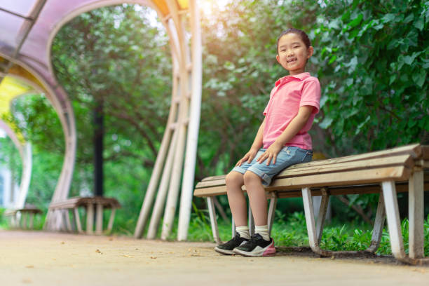 istock Little Girl Reading Book 1323492767