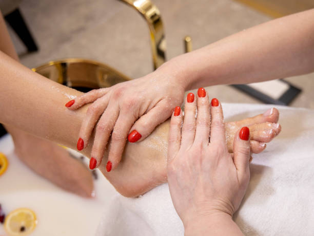 Spa treatment and massage for feet in salon stock photo