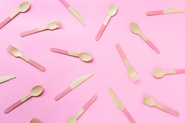 istock Texture of disposable bamboo spoons, forks and knives on pink background. Zero waste concept. Top view, flat lay 1323493809