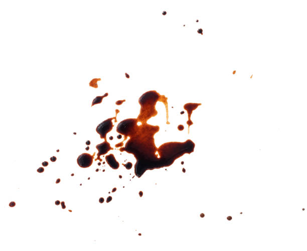 istock spilled black coffee on a white background. Large brown blot with fine splashes 1323493980