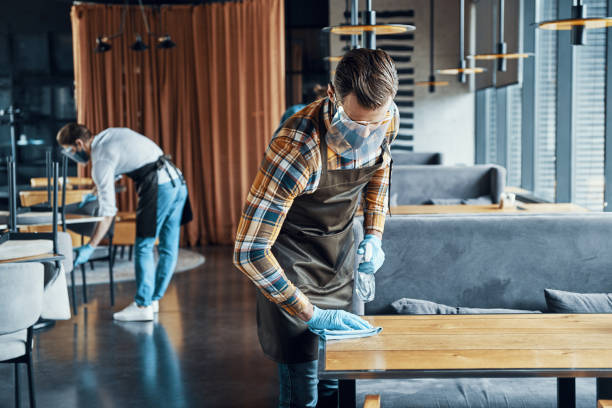 istock Busy young male waiters in protective workwear 1323495441