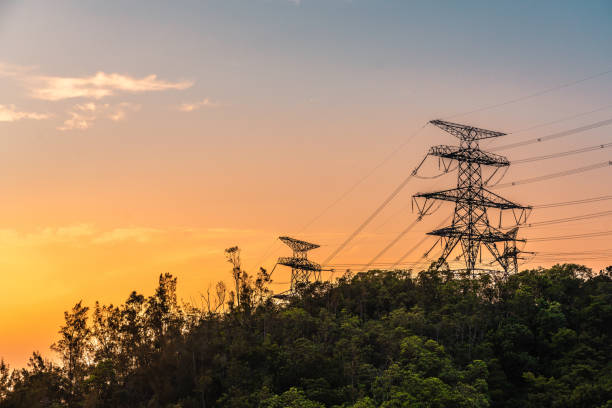 istock Electrical poles of high voltage in blue sky 1323496704