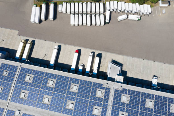 istock Aerial View of Trucks Loading at Logistic Center, Distribution Warehouse with Solar Photovoltaic Panels 1323497137