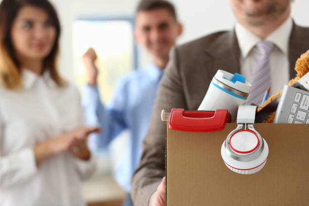 istock Collegues feeling happy while man becoming unemployed 1323497309