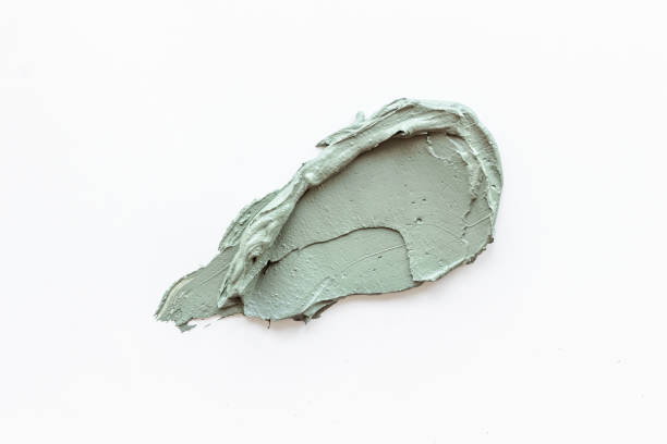 istock Cosmetic blue clay mask isolated on white background 1323501136