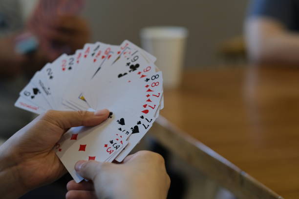 istock hand holding poker cards 1323501744