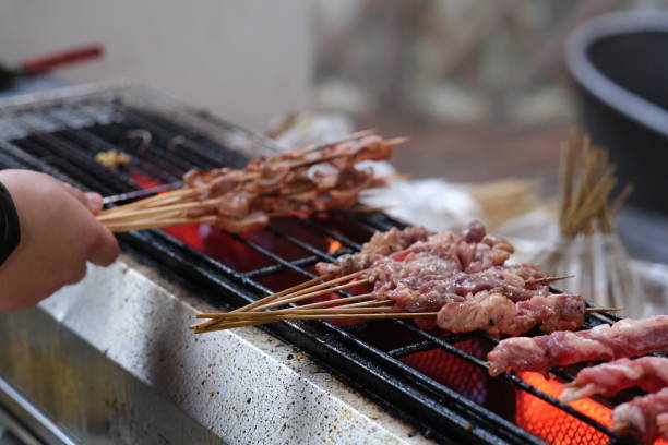 istock hand cooking barbecue on grill 1323501787