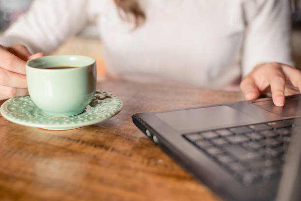 istock Young woman working while drinking coffee at home 1323502981