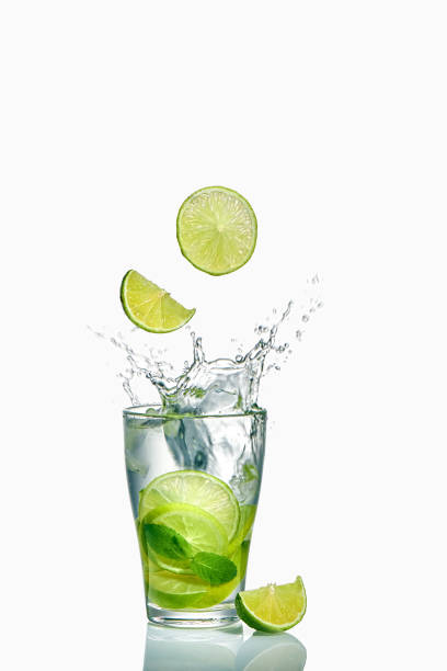 istock Lime slices splashing into an ice cocktail 1323503726