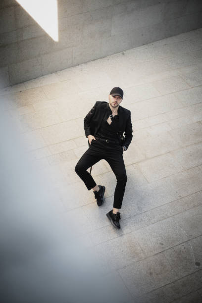 istock Modern gentleman sitting on chair 1323505604