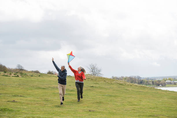 istock Friends Flying a Kite Together 1323507416
