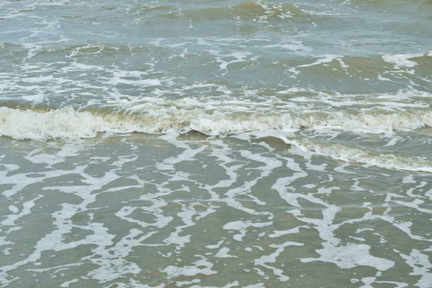istock sea wave flowing to the beach from chao Sam Ran beach in Thailand 1323508278