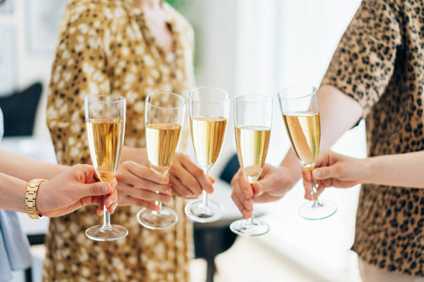 istock Young men and women making a toast 1323508810
