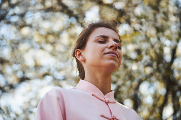 istock Female closing her eyes outside during meditation 1323510144