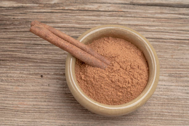 istock dried cinnamon sticks and powder on wooden table with copy space 1323511128