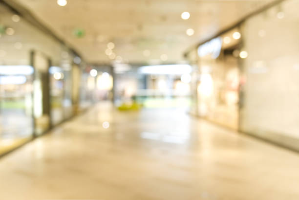 istock shopping mall blurred background. Light blur store interior with bokeh 1323511522