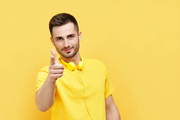 istock Handsome young man pointing at you on yellow background 1323511537