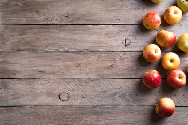 istock Apples on wooden background 1323511605