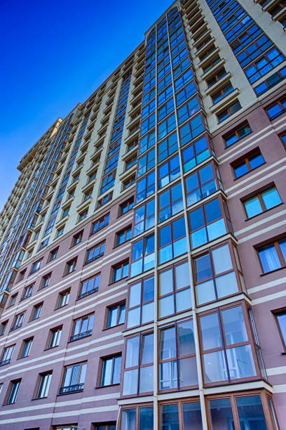 istock Architecture Concepts. New Construction Site with Civil Building Against Blue Sky.Vertical Image 1323511809