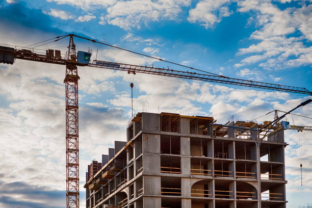 istock Construction Site with Building and Crane Against Sky with Clouds. Horizontal Image Orientation 1323511819