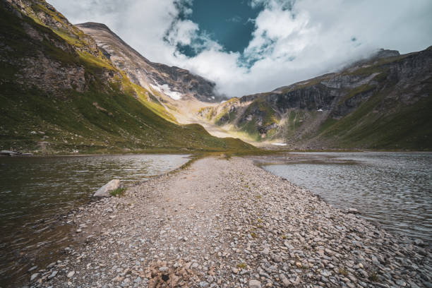 gravel path between mountain lakes high up above timber line  in alpine landscape nobody