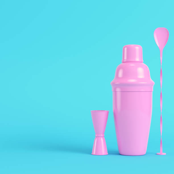 istock Pink cocktail shaker with jigger and mix spoon on bright blue background in pastel colors 1323513376