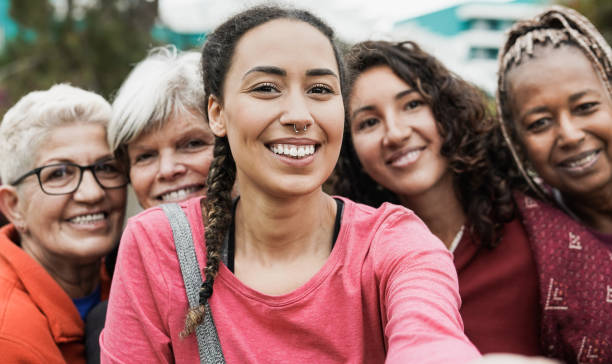 istock Multiracial women smiling in camera while taking a selfie at park after yoga class - Multi generational people concept 1323513470