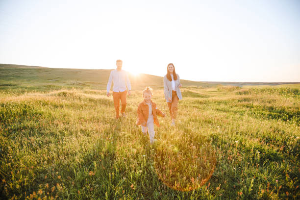 istock A hipster family walks in a summer field. 1323513564