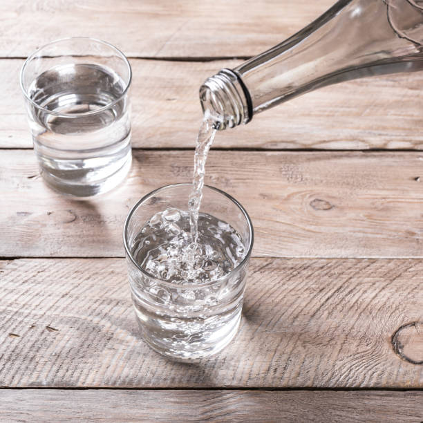 istock Water pouring into glass 1323514125