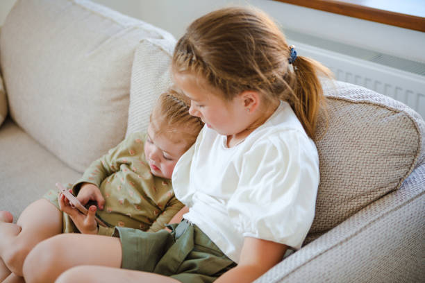 istock Children addicted to electronic technology. Home leisure. 1323514429