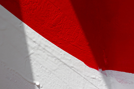 red and white wall with paint
