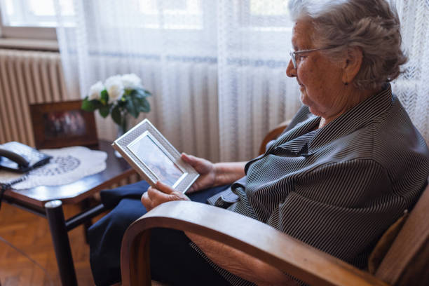 istock Senior nostalgic woman looking photo 1323518894