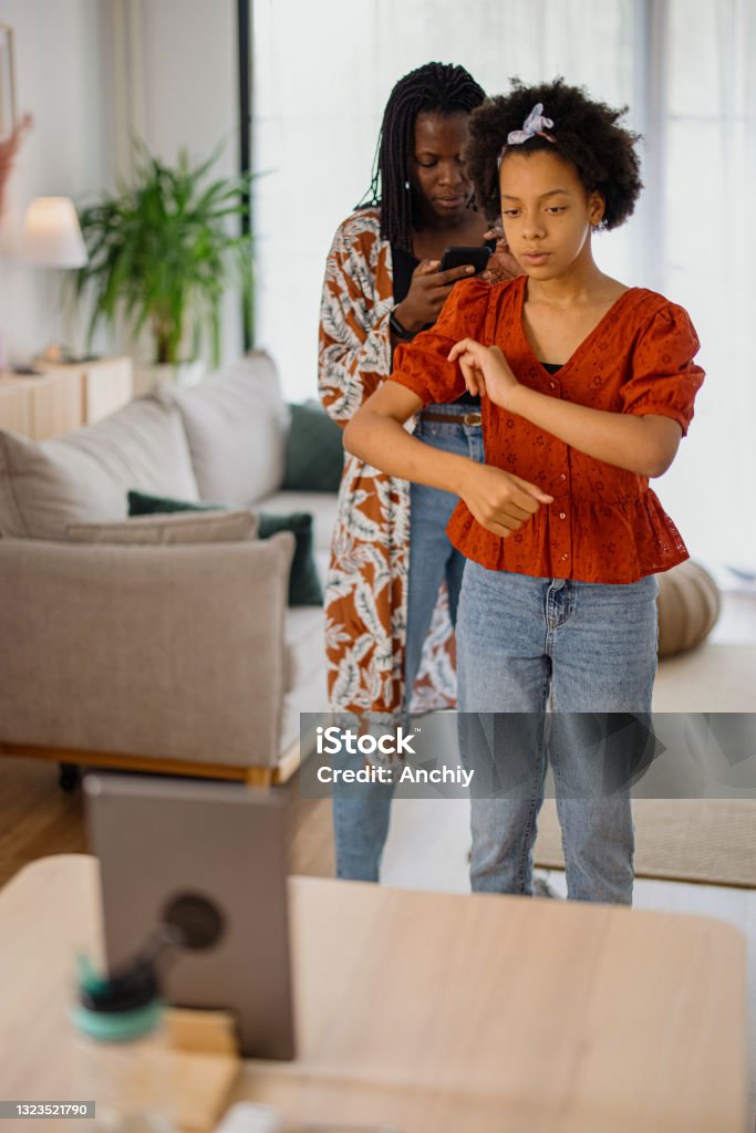 Mother and daughter recording a dance video at home Mom and daughter dancing  and making video at home, tik tok concept Viral Video Stock Photo