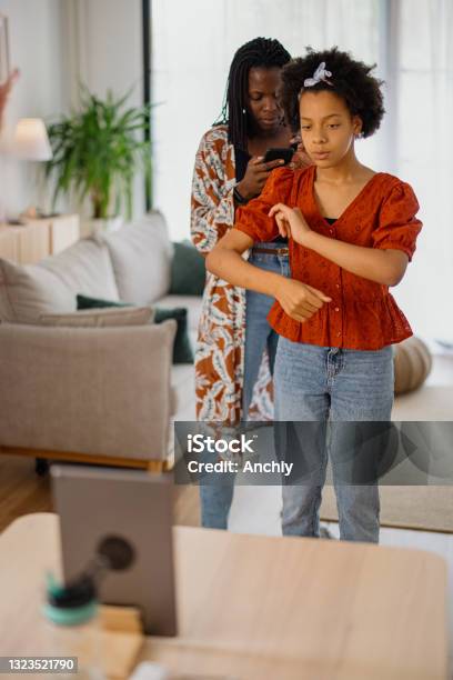 Mother And Daughter Recording A Dance Video At Home Stock Photo - Download Image Now