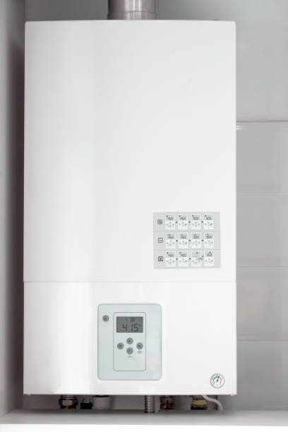 istock White electric water heater with electronic panel mounted in a kitchen cabinet 1323522218