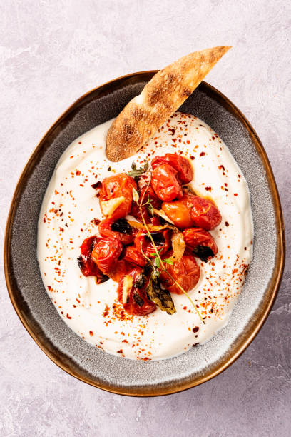 istock Oven Baked Cherry Tomatoes with Greek Yoghurt and Pitta Bread 1323523129