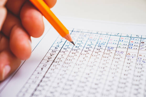 istock Modern astrologer's desktop. Hand with a pencil 1323525089
