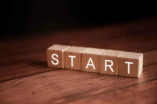 Photo of Text START on wooden cubes. Ideas for starting investments and starting a business.