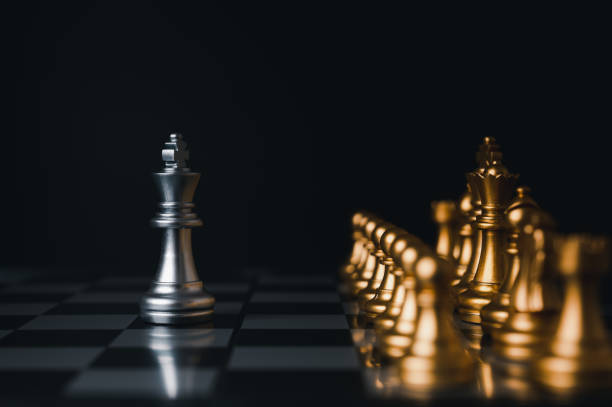 istock Silver king winner surrounded with silver chess pieces on chess board game competition.concept strategy, leadership and success business. 1323526516