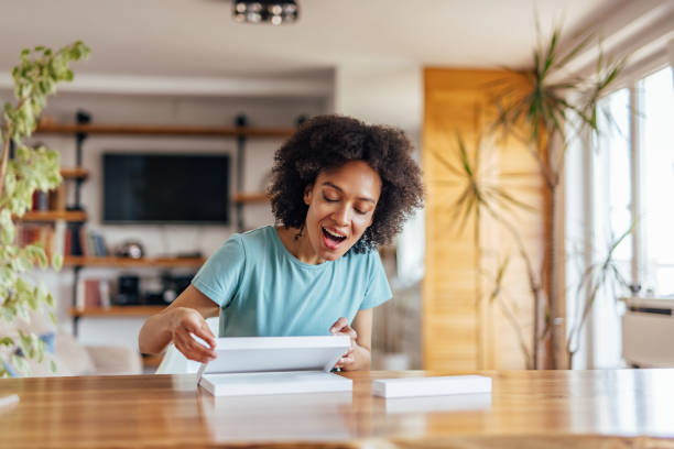 istock Adult black woman, checking out her package. 1323528723