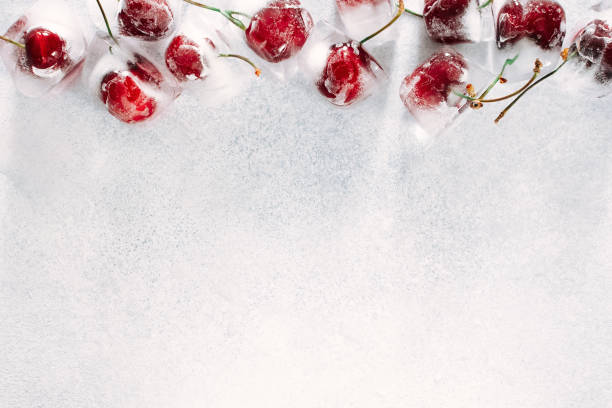istock a few frozen cherry berries lie on a light stone background 1323531250