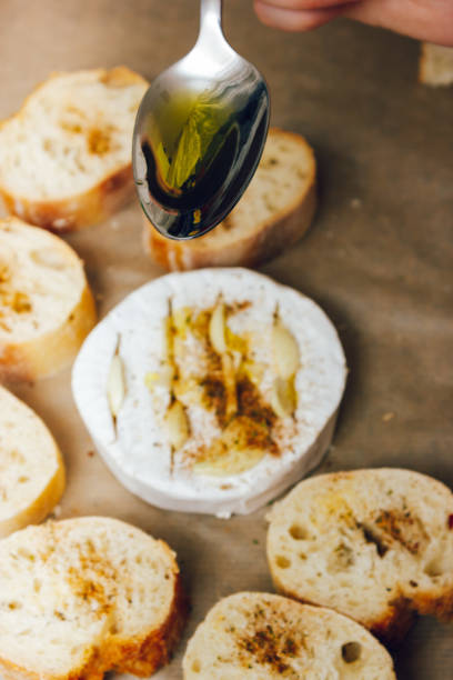 istock DIY baked cheese camembert instruction step by step. step 4 add olive oil. cheese with white mold.moldy cheese 1323533992