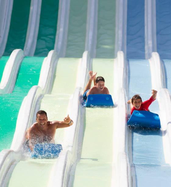 istock kids having fun sliding in water park 1323537836
