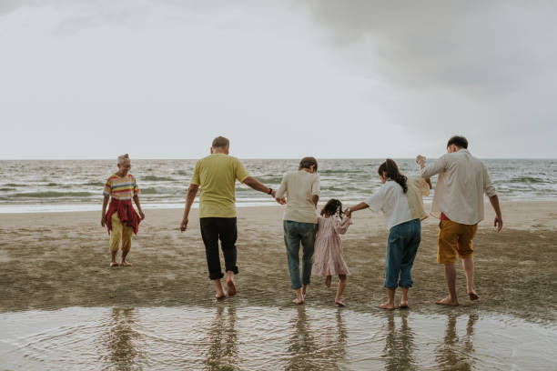 Happiness moment of family at the beach-stock photo Holding hand with Unity Thai modern family traveling the sea on weekend with positive emotion, Southeast Asian traveling together thai culture photos stock pictures, royalty-free photos & images