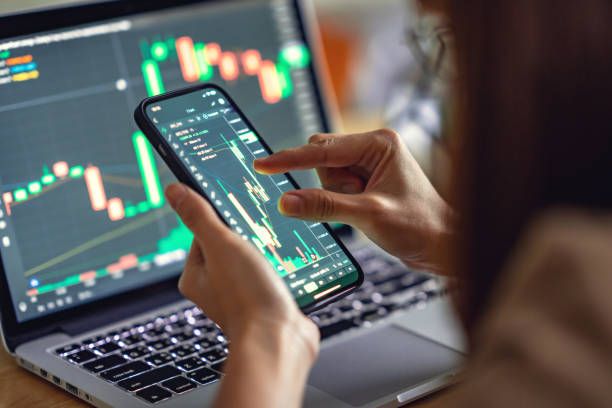 Woman is checking Bitcoin price chart on digital exchange on smartphone, cryptocurrency future price action prediction. Closeup - Woman is checking Bitcoin price chart on digital exchange on smartphone, cryptocurrency future price action prediction. cryptocurrency stock pictures, royalty-free photos & images