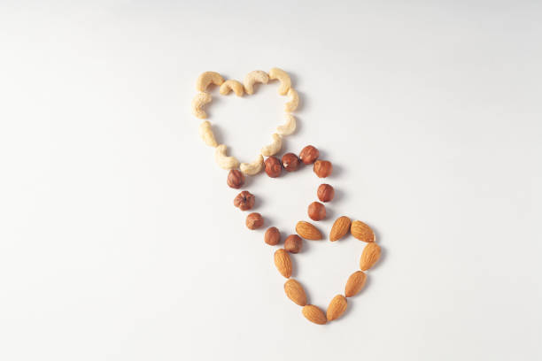 from almonds, hazelnuts, cashews are laid out three hearts. View from above.