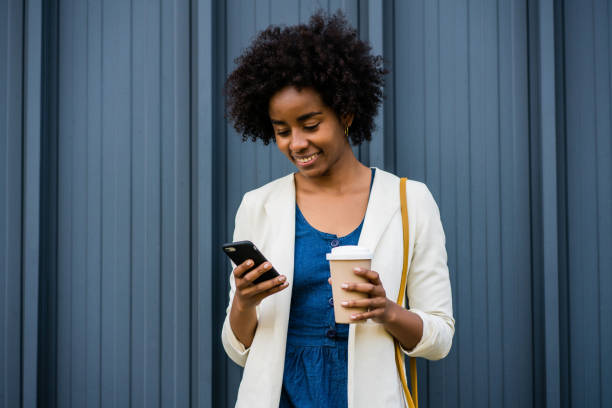 istock Business woman using her mobile phone outdoors. 1323543743