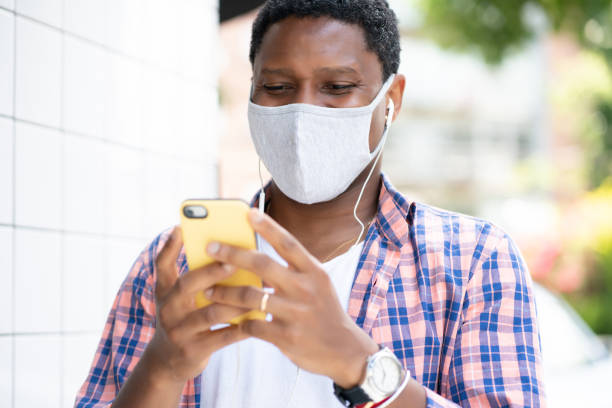 istock Man using his phone on the street. 1323545148